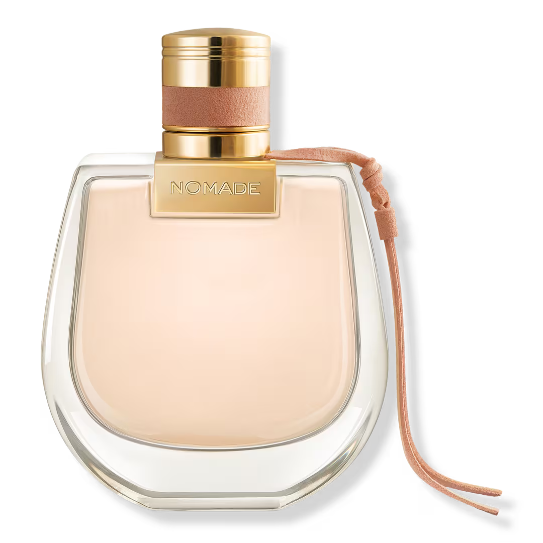 Chloé Nomade Eau de Parfum 75ml bottle with gold cap suede collar and leather cord on white background